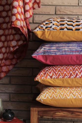 a stack of pillows sitting on top of a table at Cool Covent Garden Theatre Design Hub for Families Friends Couples in London