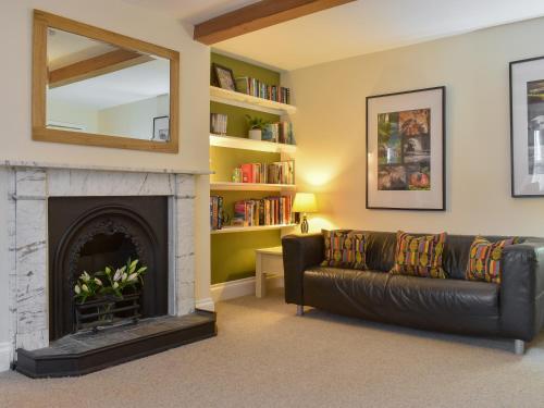 a living room with a couch and a fireplace at The Garden Apartment - Uk32517 in Whitby