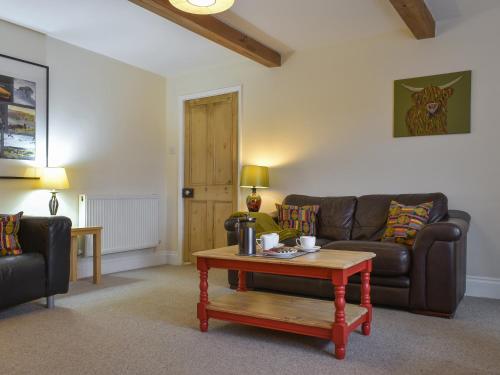 a living room with a couch and a coffee table at The Garden Apartment - Uk32517 in Whitby