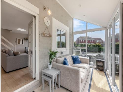 a living room with a couch and a table at Water's Edge Holiday Home in Beadnell