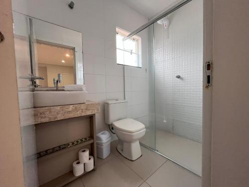 a bathroom with a toilet and a sink and a shower at Pousada Bela By Bia - Comfort in Penha