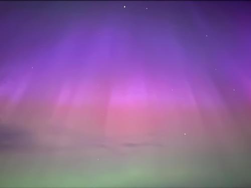 a stage with pink and purple lights in the sky at The Hobbit in Inverallochy