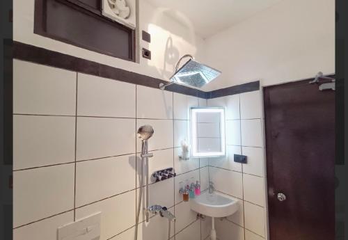 a bathroom with a sink and a mirror at Gorgeous villa near Eden beach in Puducherry