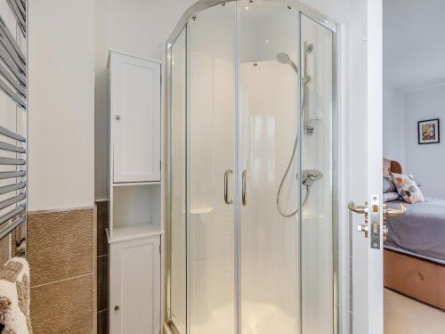 a glass shower in a room with a bed at One The Loan in Croy
