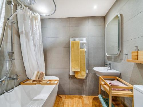 a bathroom with a tub and a sink at The Coach House in Southwell