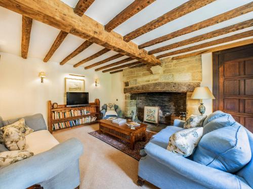 a living room with two couches and a fireplace at Pinley Hill House in Shrewley
