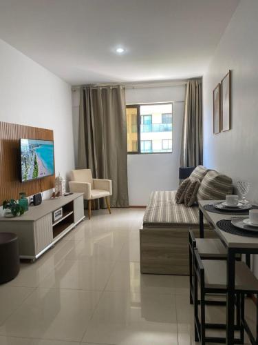 a large living room with a couch and a tv at Flat Costa Nova VIP - em Ponta Verde - Apartamento 202 - 1 Quarto - Proximo a Praia in Maceió