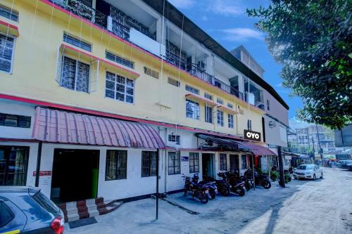 a building with motorcycles parked in front of it at SPOT ON Rainbow Lodge in Guwahati