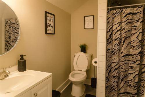 a bathroom with a toilet and a sink at Where Class Meets Comfort in Knoxville