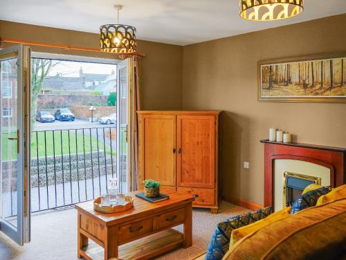 a living room with a couch and a table at Norwood in Thornhill