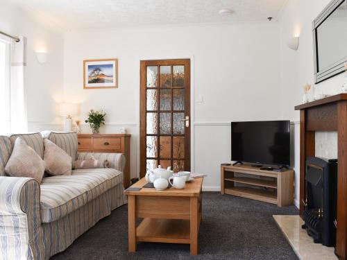 a living room with a couch and a tv at Ballyholme in Skelton