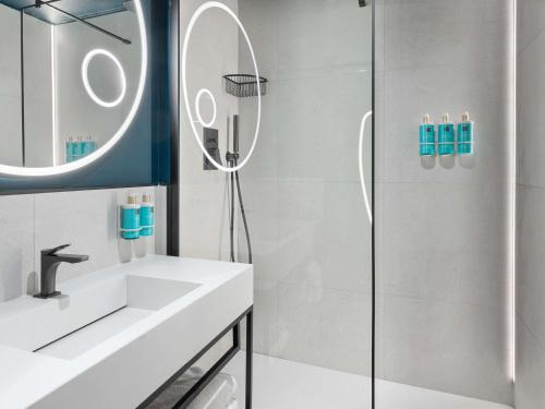 a bathroom with a shower and a sink at Novotel Caserta Sud in Caserta