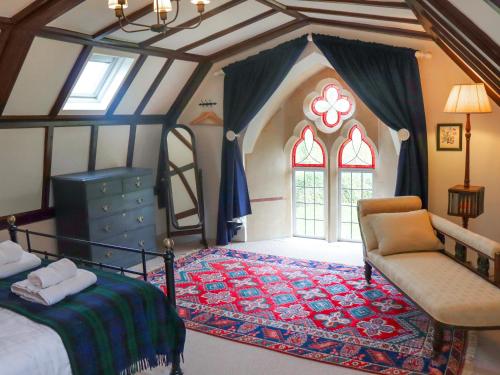 a bedroom with a bed and a chair and a window at St Peters in Highway