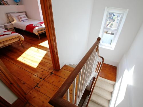 a room with a staircase with a bed and a window at Dreamers View in Margate