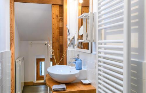 a bathroom with a white bowl sink on a wooden counter at Beautiful Home In Porto Potenza Picena in Porto Potenza Picena