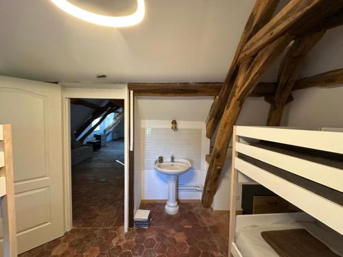 a bathroom with a sink in the middle of a room at Domaine de Chatillon 
