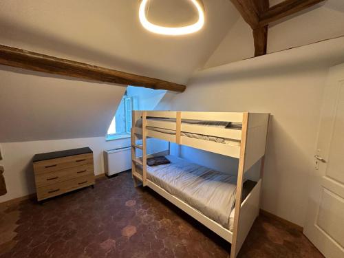 a bedroom with two bunk beds and a dresser at Domaine de Chatillon 