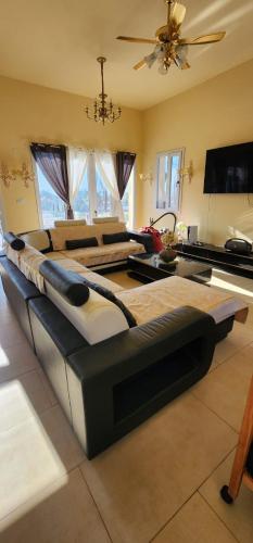 a large bed in a living room with a ceiling at Golden House in Kidmat Tsvi
