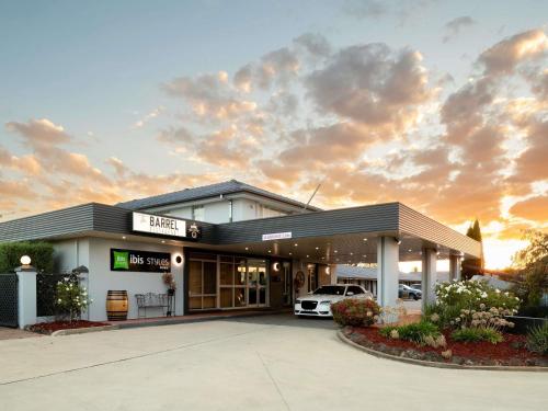 a dealership with a car parked in front of it at ibis Styles Orange in Orange
