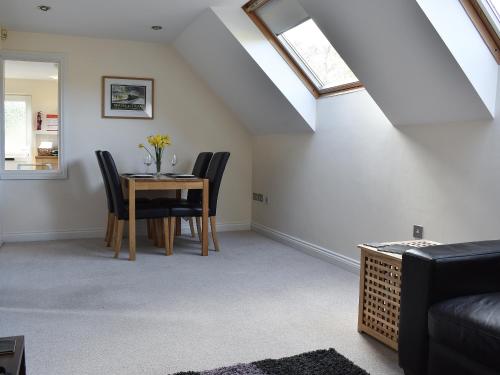 a living room with a table and chairs at The Dell in Minehead