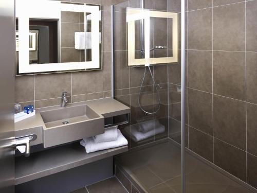 a bathroom with a sink and a shower at Novotel Marseille Centre Prado Vélodrome in Marseille