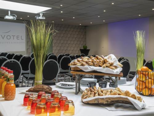 a table with bread and other food on it at Novotel Marseille Centre Prado Vélodrome in Marseille