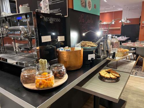 a bakery with a counter with food on it at Novotel Marseille Centre Prado Vélodrome in Marseille