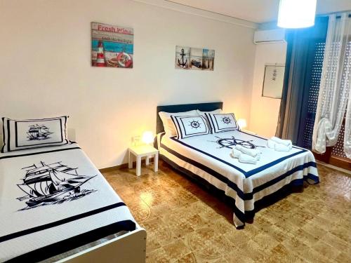 a bedroom with two beds and a window at Gente di Mare Apartment Tropea Center in Tropea