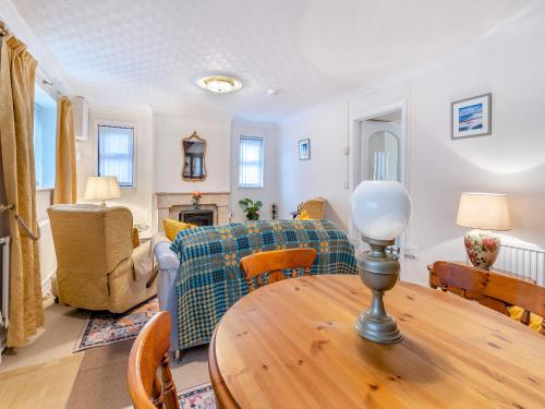 a living room with a table and a couch at Pant Glas Cottage in Pontardawe