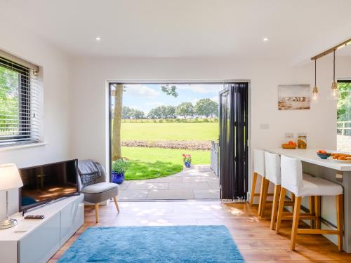 a kitchen with a view of a yard at Willow Cottage in Stonham Aspall