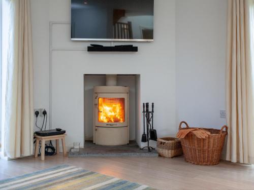 a fireplace with a fire in it in a living room at Lark Rise in Northam