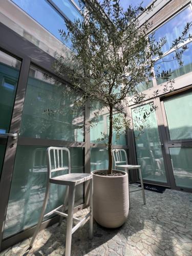 a table and two chairs and a tree in a building at LoftDesign in Verona