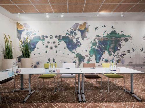 a meeting room with a map of the world on the wall at Ibis Styles Regensburg in Regensburg