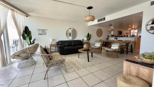 a living room with a couch and a table at Relax and Retreat at BellaView603 - Comfortable Oceanfront Condo in Daytona Beach