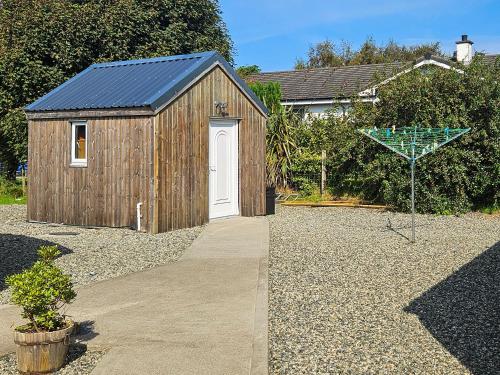 a small wooden shed with a blue roof at Harris - Uk34048 in Stornoway