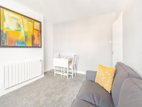a living room with a couch and a table at Buttercup Apartment - Uk42382 in Bridlington
