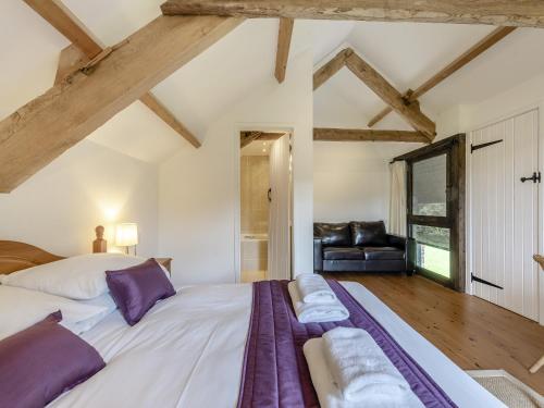 a bedroom with a large bed and a couch at Y Stabl in Llanwrda