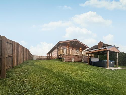 a large yard with a barn and a fence at Coo Lodge - Uk48430 in Falkirk