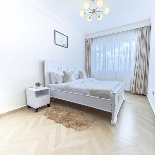 Postel nebo postele na pokoji v ubytování Indesign makumbi Apartment