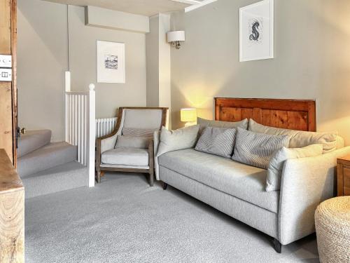 a living room with a couch and a chair at Whalers Cottage in Whitby