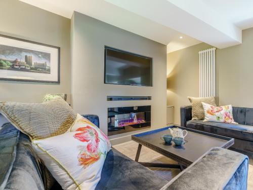 a living room with a couch and a table at Frenchgate Mews in Richmond