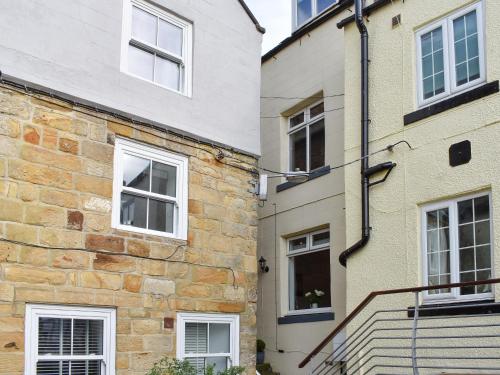 an old stone building with white windows and stairs at Hidden Gem in Willingham