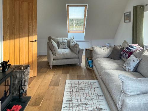 a living room with a couch and a chair at Walnut Cottage Barn in Clevedon