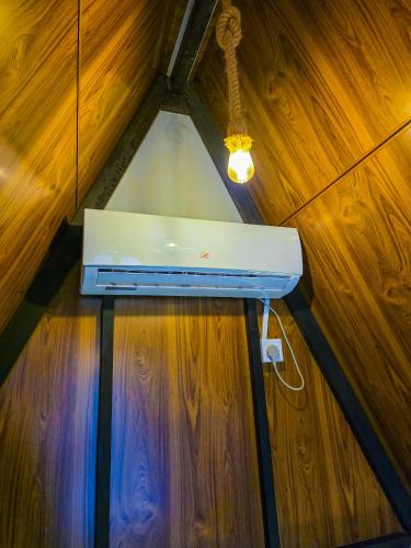 a white router sitting on top of a wooden wall at Ella Happy View Homestay in Ella