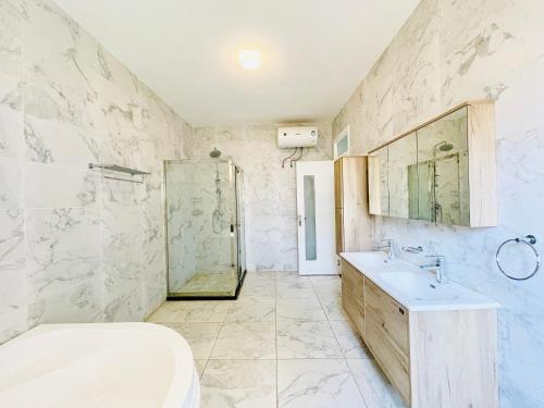a bathroom with a sink and a shower at May Homes III in Kampala