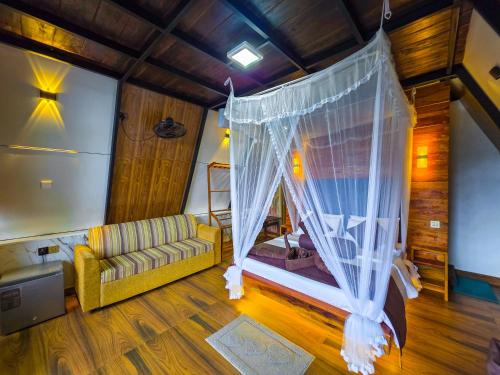 a living room with a couch and a canopy at Ella Happy View Homestay in Ella