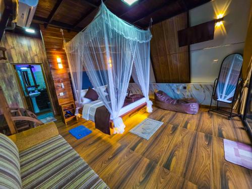 a bedroom with a bed with a canopy at Ella Happy View Homestay in Ella