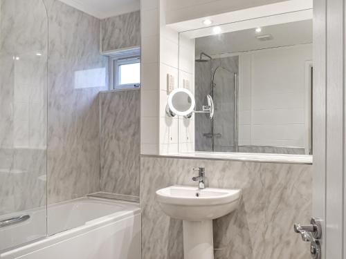 a bathroom with a sink and a toilet and a mirror at Whitey Top Country Lodge in Pentridge