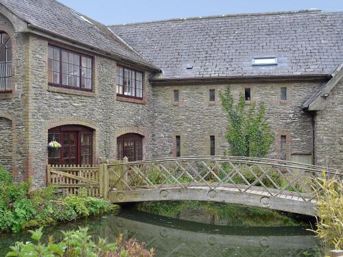 a bridge over a river in front of a building at Bridge House - Ukc1340 in North Molton