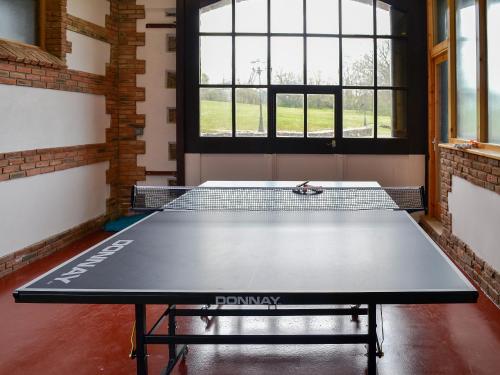 a ping pong table in a room with a tennis court at Bridge House - Ukc1340 in North Molton